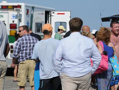 Bystanders gathered as Juan Carlos Salvana, 30, of Long Island City was loaded into an ambulance after coming close to drowning at Main Beach in East Hampton Village last Thursday.