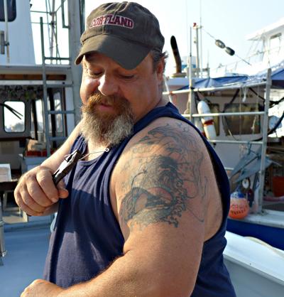 Preparing for a trip Tuesday morning, Rob Aaronson, captain of the charter boat Oh Brother, talked fish and gave a tour of his tattoo that depicts his boat, his daughter, the Montauk Lighthouse, and of course, the sea.