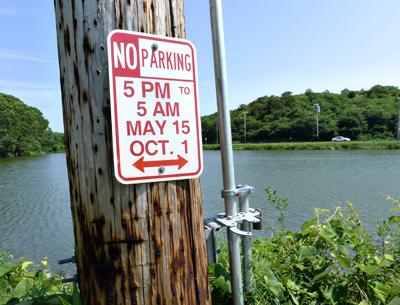 Parking signs like this one on Industrial Road in Montauk have repeatedly gone missing, and police ticketing blizzards have been one result.