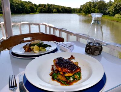 Curry-seasoned chicken and striped bass, with Chase Creek, green and quiet, in the background.