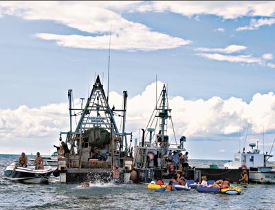 The Anna Mary, anchored in Fort Pond Bay in Montauk Sunday, served as bandstand at a party to celebrate the rescue at sea two weeks ago of John Aldridge, a co-owner of the lobster boat. Lobsters were in copious supply.