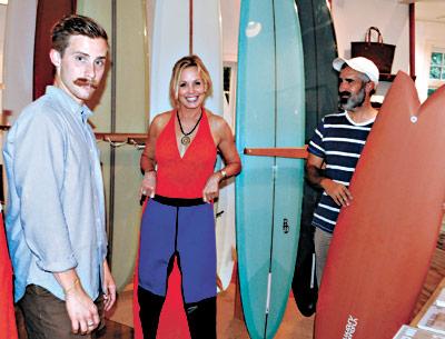 Eric Degenhardt, left, the manager of Pilgrim Surf + Supply, posed with a customer, Susan Jackson, and the store’s owner, Chris Gentile, in the newly renovated shop at Amagansett Square.  	Morgan McGivern