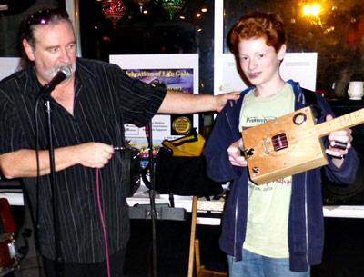 The guitarist Kerry Kearney, left, was so taken by Casey Baron and his cigar-box guitars that he asked the 13-year-old to open his next performance.