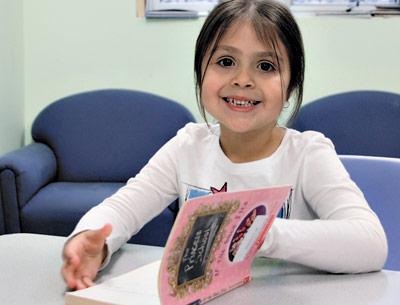 Hannah Salazar, a 5-year-old student at the Child Development Center of the Hamptons, read in the school’s library last week.