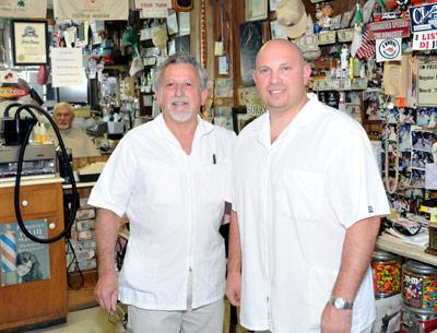 Vinnie Mazzeo, left, and his son and business partner, Nick, will move Vinnie’s Barber Shop from its iconic Main Street location to a new spot in Amagansett Square by New Year’s Day.