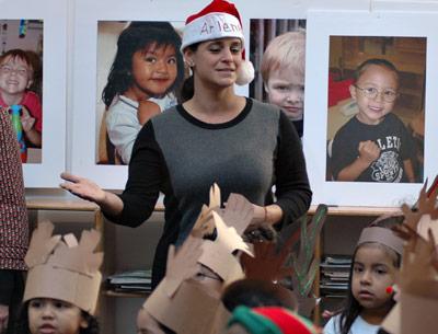 Arlene Notel, a prekindergarten teacher at the Eleanor Whitmore Early Childhood Center, encouraged her students during a holiday sing-along at the center yesterday.