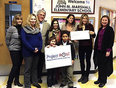 The founders of the Hamptons Marathon, Amanda Moszkowski and Diane Weinberger, holding the check in back, got a big thank-you for their donation to Project Most at the John M. Marshall Elementary School Friday from Christina DeSanti, Beth Doyle, the school principal, East Hampton Town Supervisor Larry Cantwell, Anita Wright, a parent, Rebecca Morgan Taylor of Project Most, and two kids who take part in the program.