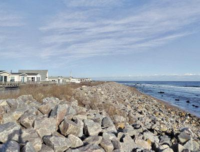 A stone sea wall at the Montauk Shores Condominium in Montauk will be reduced in size and planted with beach grass as part of an agreement between the property association and New York State.