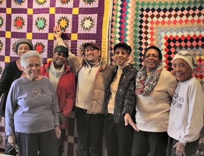 The Eastville Community Historical Society board celebrated the installation of a new quilt show on Saturday in Sag Harbor. From left, Kathy Tucker, Jackie Vaughan, Gloria Primm Brown, Michael Butler, Beryl Banks, Audrey Gaines, and Elinor Fendall stood in front of two quilts made by Patricia Turner, the curator of the show.