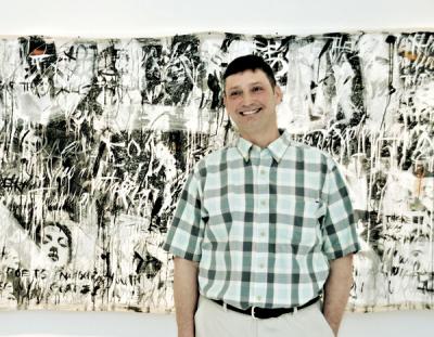 Matt Vega stood in front of his word painting “Resolution and Independence” at the opening of his show at Ille Arts in Amagansett.