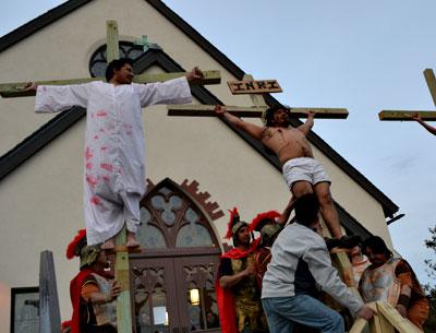 Ricardo Santos, Adrian Sanchez, and Marco Gutama were raised on crosses in the crucifixion scene from a Spanish-language production of the passion play at St. Therese of Lisieux Catholic Church in Montauk Friday.