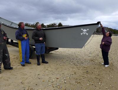 At Barnes Landing on Sunday, Susan Denton christened the Miss Mary with a bottle of Budweiser. Her husband, Dwayne Denton, built the new dory for Paul and Dan Lester.