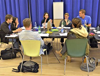 Scott Schwartz, the director, and Carey Crim, the author of “Conviction,” at left, exchanged ideas with the cast during an early rehearsal in New York. Bill Hutchison and Elizabeth Reasor had their backs to the camera, while opposite them were Sarah Paulson, Daniel Burns, and Garret Dillahunt.