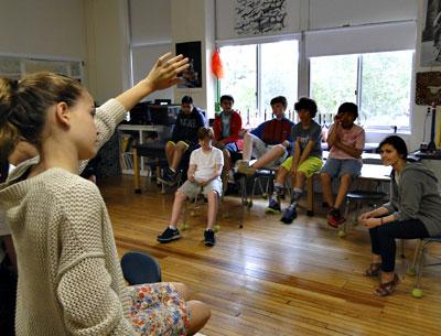 Joanna Howard, seated at right, a teaching artist with Project Hero, oversaw a group session with East Hampton Middle School students on Friday.