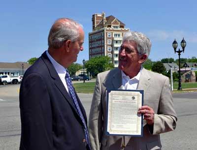 John Keeshan, who successfully lobbied to rename the Plaza after Carl Fisher, received a copy of the East Hampton Town resolution making it official on June 24 from Supervisor Larry Cantwell.