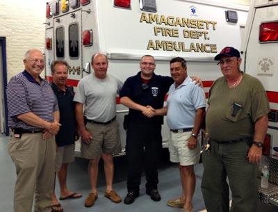 Nick Calace, third from right, a paid paramedic with the Amagansett Fire Department ambulance company, has been recognized for the care he gave a patient having a heart attack on July 9. He posed for a photograph with the fire district commissioners, from left, Jack Emptage, J. Kent Howie, William Vorpahl Jr., Daniel R. Shields II, and Carl Hamilton.