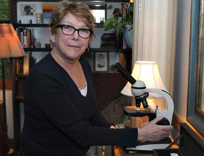 With microscope in hand, Patricia Hope is at work on a study cataloging local ticks and mites.