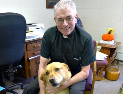 The Rev. Thomas Patrick Murray of St. Therese of Lisieux Catholic Church, with his dog, the Monsignor, compares Montauk to Mayberry.