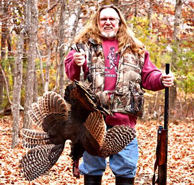 Harvey Bennett, Thanksgiving provider, with wild turkey in hand