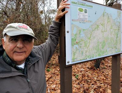 Tony Garro is justifiably proud of the brand-new, colorful, and color-coded hamlet-to-hamlet footpath kiosks, like this one at Trout Pond in Noyac.