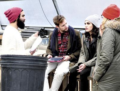 Richie Duque, above left, a cinematographer, discussed a scene with David Rysdahl and Shaun Licata, the actors, and Jill Campbell, right, the director of one of the Dogme film projects. Below, Magdalene Brandeis and Lenny Crooks posed in front of a mural-sized matrix outlining the production details of the seven Dogme films.