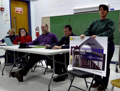 Lisa DeVeglio of the Montauk Playhouse Community Center Foundation held a rendering of the center as it would look after a major renovation that includes the addition of an aquatics center.