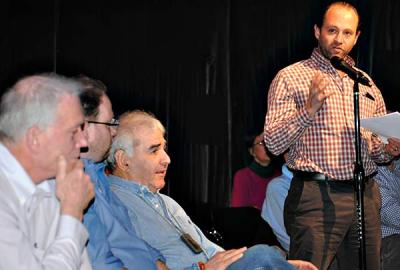 Jonathan Sabin, standing, and his father, Andrew Sabin, seated to his left, said that the town board’s proposed East Hampton Airport regulations are too restrictive.