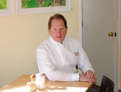 Colin Ambrose, above, the owner and chef of Estia’s Little Kitchen in Sag Harbor, has a longstanding relationship with the region’s artists. Barbara Thomas, below, will exhibit paintings of vegetables from her garden, including a variety of carrots, at the restaurant during April and May.