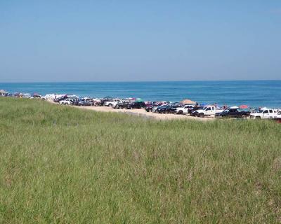 Four-wheel-drive vehicles lined the beach in a 2011 photograph of a portion of the Napeague oceanfront that is the subject of a lawsuit by a group of property owners seeking to end vehicle access there.