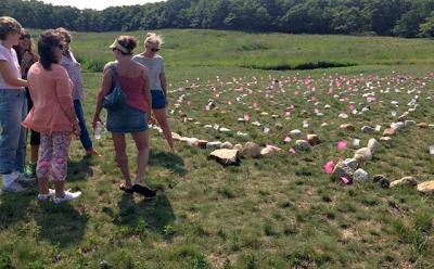 Members of a Montauk group called 12 Women put the finishing touches recently on a stone labyrinth they laid out in the field at Eddie V. Ecker County Park on Navy Road.