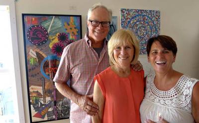 Tom Griffin, a board member, and his wife, Helene Griffin, with Lisa DeVeglio, the president of the Montauk Playhouse Community Center Foundation, at the opening reception Saturday for a pop-up art gallery to benefit the Playhouse.