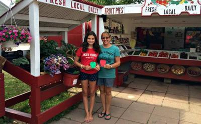 Vicki Littman, right, and her daughter, Maria, with the apples that represent donations earmarked for the East Hampton Food Pantry.