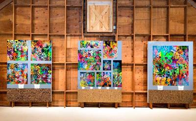 Ryan McGinness’s paintings line the back wall of the gallery loft.