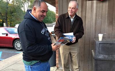 Tom Knobel, right, the Republican candidate for East Hampton Town supervisor, spent Tuesday morning handing out his campaign literature.