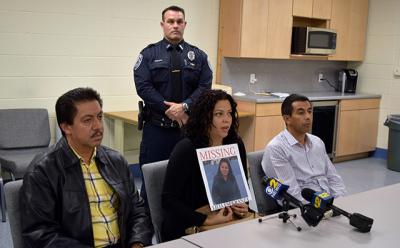 Maria Duchi held a poster with her aunt Lilia Aucapina’s photograph. Ms. Duchi spoke at a Southampton press conference on Oct. 21 about Ms. Aucapina’s disappearance. With her were Ms. Aucapina’s brother, Victor Parra, left, and Carlos Parra, right.