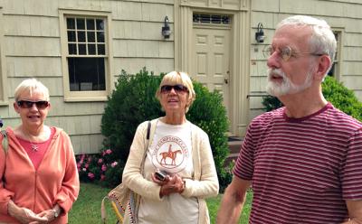 Richard Barons, right, led a 2014 East Hampton Historical Society walking tour that included a stop at the historic Village Hall building.