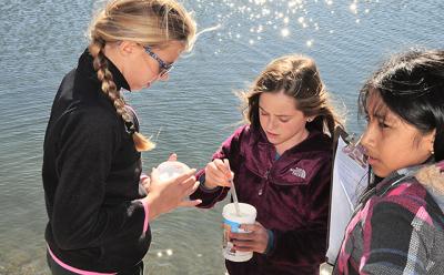 From left, Jameson Grant, Devyn Eames, and Milena Torres worked together to measure various aspects of water quality at Louse Point on Oct. 23 as part of the Day in the Life of the Peconic Estuary program.