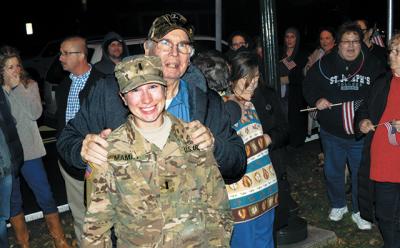 A crowd gathered at Hook Mill in East Hampton on Friday to welcome home Army Reserve First Lt. Elizabeth Mamay from a nine-month deployment. Among the well wishers was her grandfather John McNally.