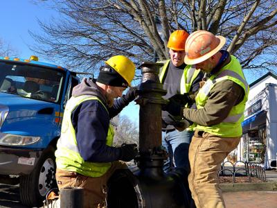 Workers on Newtown Lane, East Hampton, yesterday, part of a water authority project that will continue into the spring.