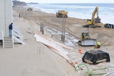 Contractors for the Army Corps of Engineers are moving down the Montauk beach to construct a mostly buried wall of sandbags. The first section, at the western end of the downtown shore, has been completed.  	Morgan McGivern Contractors for the Army Corps of Engineers are moving down the Montauk beach to construct a mostly buried wall of sandbags. The first section, at the western end of the downtown shore, has been completed.