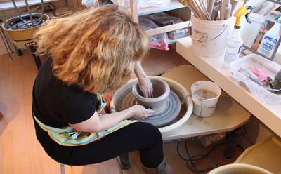 Eve Behar, a professional ceramic artist who is the president of the Clay Art Guild of the Hamptons, digs deep and gets her hands full of clay at the potter’s wheel, throwing what would eventually become a wide-mouthed bowl.