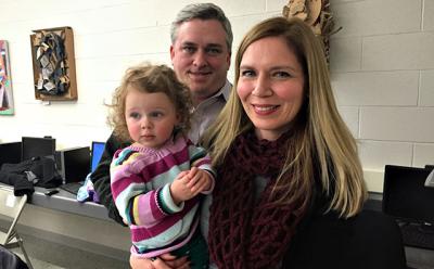 Beth Doyle, right, the principal at the John M. Marshall Elementary School, was granted tenure on Tuesday night. There with her were her husband, Michael Guinan, an assistant principal at Pierson High School, and their daughter, Olive.