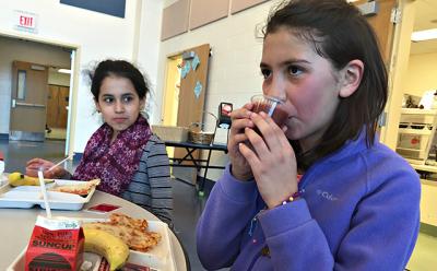 Jhoselin Narvaez Gutierrez, left, and Joana Gutierrez, fifth graders, chose smoothies made from strawberries, spinach, bananas, and apple juice during a recent lunch period at the John M. Marshall Elementary School.