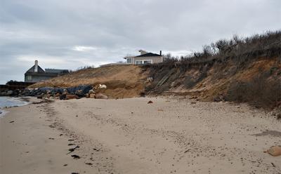 The owner of the Soundview Drive house at center is facing charges related to installing a stone revetment without proper permits.