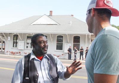 While East Hampton Village police stood guard at the East Hampton train station Sunday morning, Shelwyn Hendy, a Long Island Rail Road conductor talked to Teddy Montalvo, a passenger evacuated from the train after the Metropolitan Transportation Authority received a bomb threat.