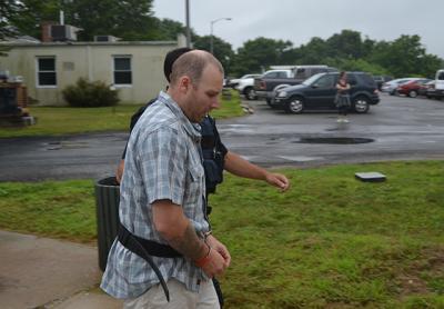 Timothy M. Egan, shown here before his arraignment last Thursday, has been charged with assault after allegedly punching a man hard enough to cause bleeding on the brain.