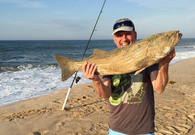 Jonathan Whitestone with a striped bass caught on bunker chunk from White Sands Beach on Napeague.