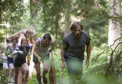 Ben Cash (Viggo Mortensen) leads his children in a forced march through the woods as part of their survival training in “Captain Fantastic.” Below, his character enjoyed a quiet moment with his daughter on the steps of their cabin.