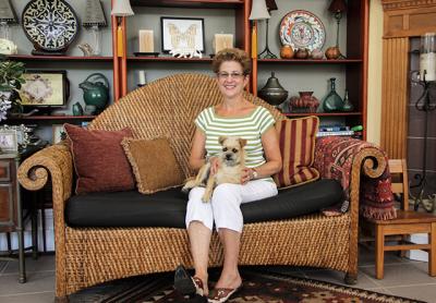 Marcia Previti, whose garden is a series of rooms enlivened by her architectural background and sculptures, below, sat at home with her dog, Dallas, on a recent afternoon.