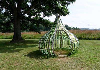 Dennis Oppenheim’s “Terrestrial Studio” exhibition at the Storm King Art Center includes outdoor installations from the artist’s estate, such as “Electric Kiss,” in stainless steel and colored acrylic rods, and “Entrance to a Garden,” which has a monumental sculpture in painted steel, along with the artist-designed landscape.